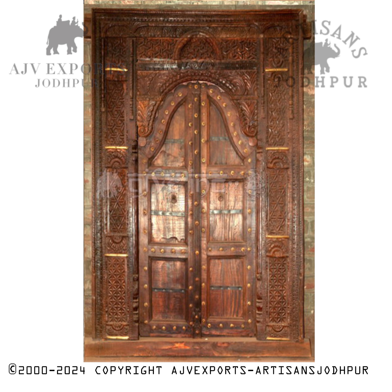 Wooden door with intricate carvings and arch